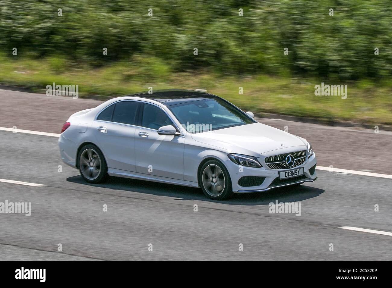 2014 Mercedes-Benz C250 Amg Line Bluetec White Car Diesel driving on the M6 motorway near Preston in Lancashire, UK Stock Photo