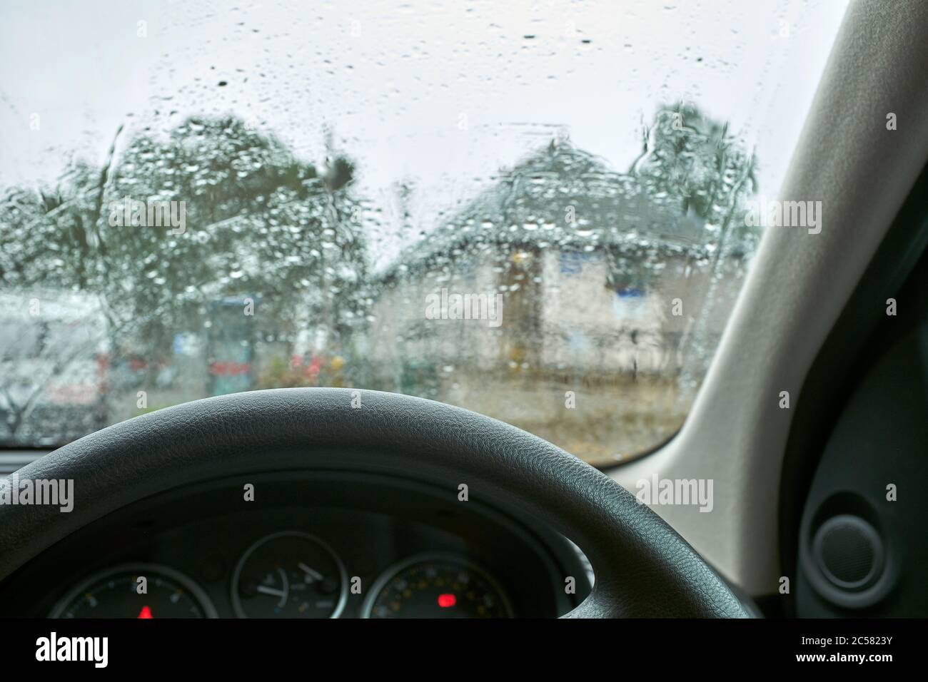 Sheltering in the car during a heavy downpour in July in the centre of Braemar Stock Photo
