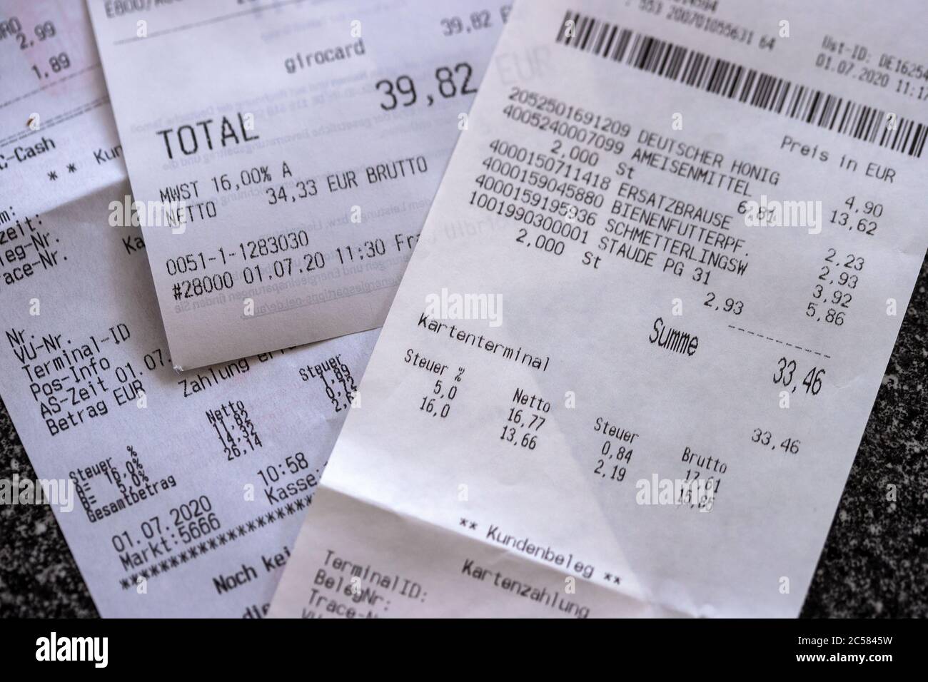 Schwerin, Germany. 01st July, 2020. Purchase receipts with the details of the new value added tax at 5 or 16 percent are on a kitchen table. From 01.07.2020, only 16 instead of 19 percent VAT will be charged for half a year when shopping, the reduced rate will drop from 7 to 5 percent. With this, the Federal Government wants to boost consumption again after the Corona crisis. Credit: Jens Büttner/dpa-Zentralbild/dpa/Alamy Live News Stock Photo