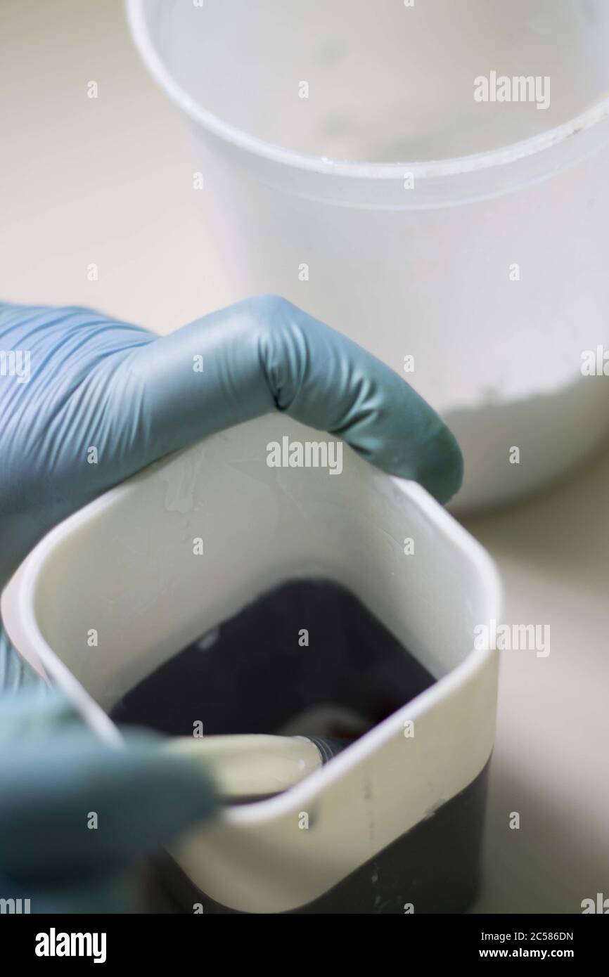 Mixing ingredients for beauty treatment wearing gloves Stock Photo Alamy