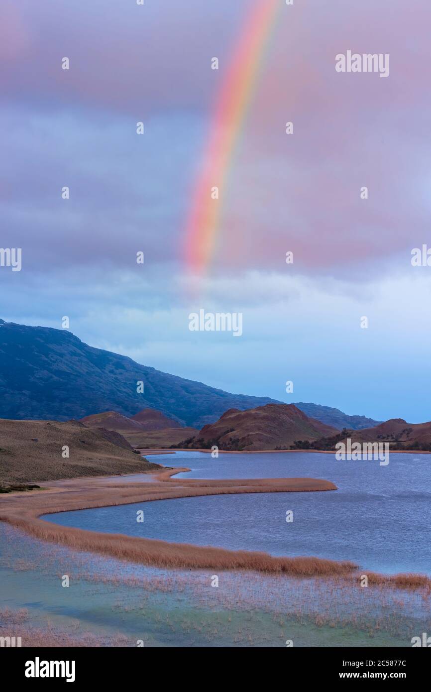 Rainbow over a laguna with marsh grass, Patagonia National Park, Chacabuco valley near Cochrane, Aysen Region, Patagonia, Chile Stock Photo