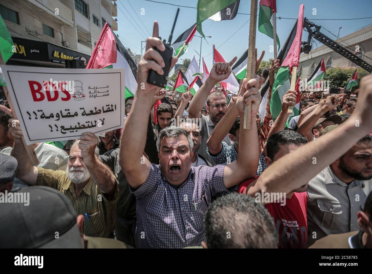 Gaza City, Palestinian Territories. 01st July, 2020. Palestinians hold placards and shout slogans as they take part in the "Day of Rage" demonstration to protest against the Israeli annexation plan that will occupy about 30 percent of the West Bank area. The annexation plan would give Israel control over the controversial Jewish settlements in the West Bank and the strategic Jordan Valley. Credit: Mohammed Talatene/dpa/Alamy Live News Credit: dpa picture alliance/Alamy Live News Stock Photo