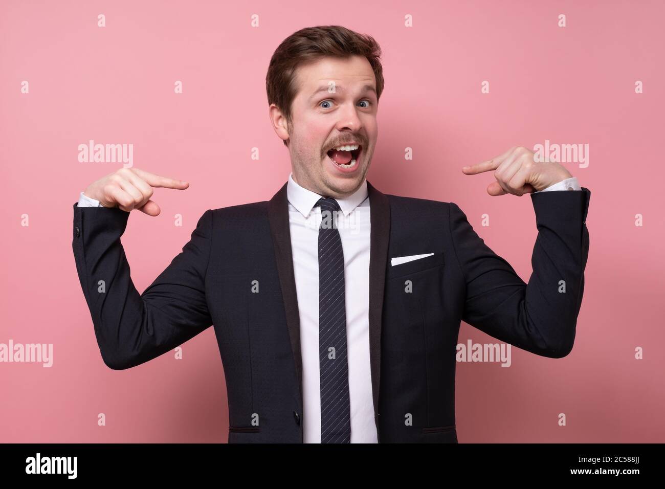 Man proud of himself pointing on his chest over pink background. I am the best concept. Stock Photo