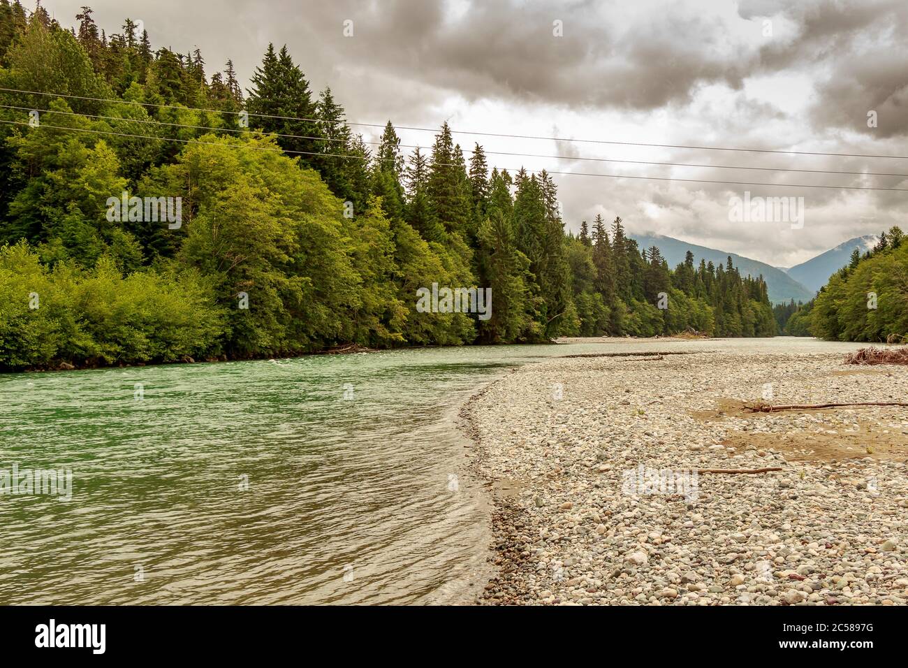 Upper Kitimat, glacial green river, on a cloudy summer day, with rainforests and gravel bars, in British Columbia, Canada Stock Photo