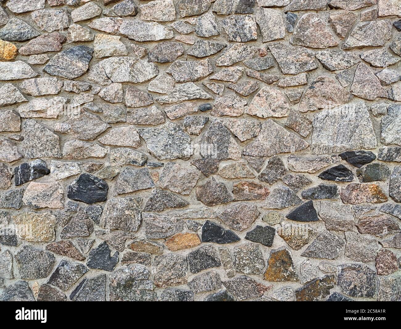 Background of large stones wall texture with different colors stones Stock Photo