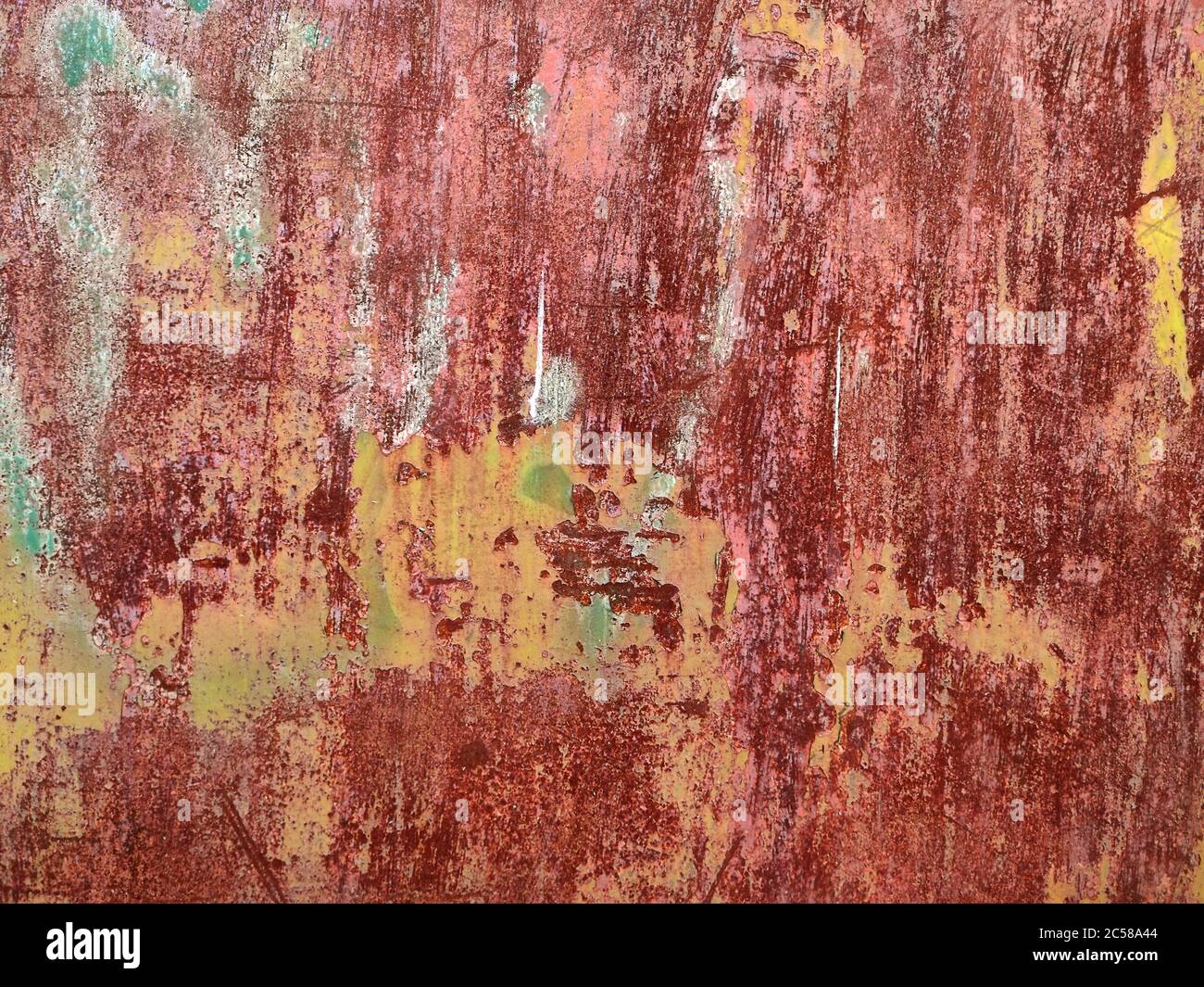 Rusted colorful painted metal wall. Rusty metal background with streaks of rust. Corroded metal background. Rust stains. The metal surface rusted spot Stock Photo