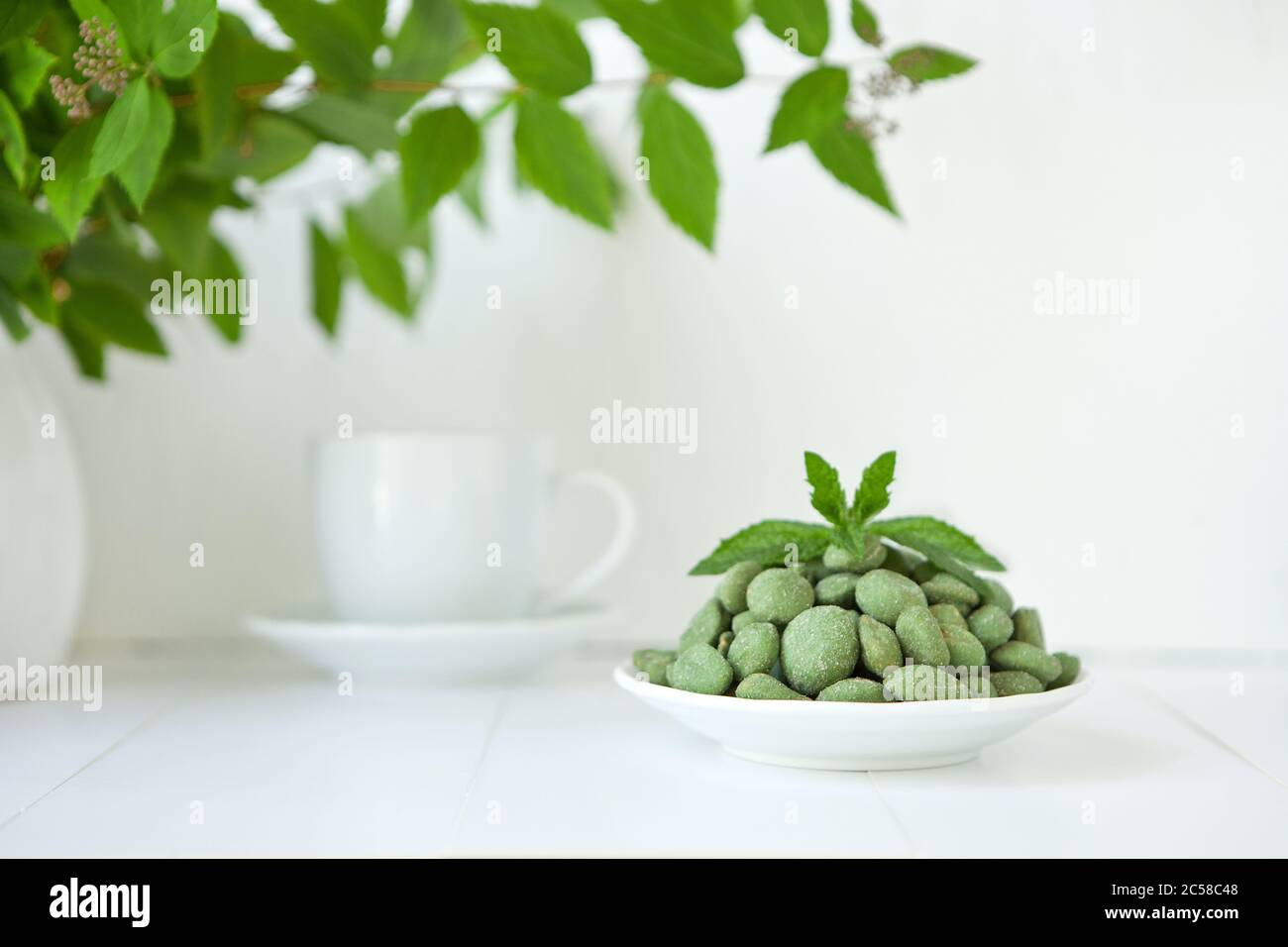 Selection of healthy food for heart, life concept. green nuts on wasaby or canabis coat on pure white background Stock Photo