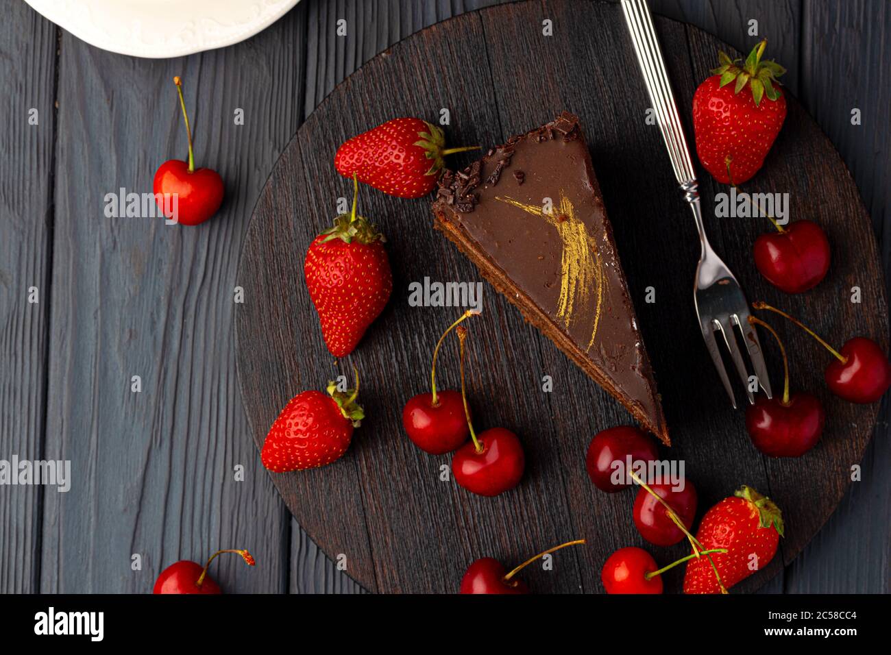 Piece of chocolate cake served with fresh berries Stock Photo - Alamy