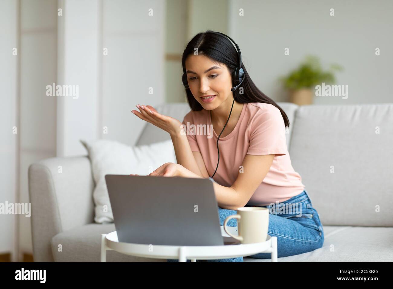 Girl Making Video Call Using Laptop Sitting On Couch Indoors Stock ...
