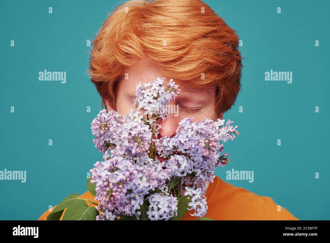 Closeup of redhead man without allergy keeping eyes closed while