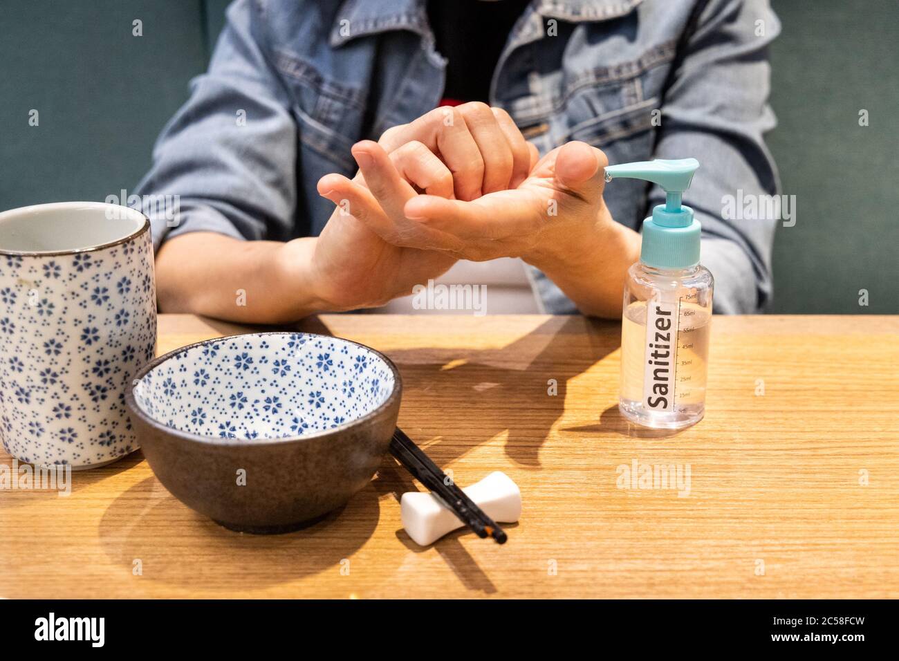 Series of person cleaning hands after spraying with disinfectant