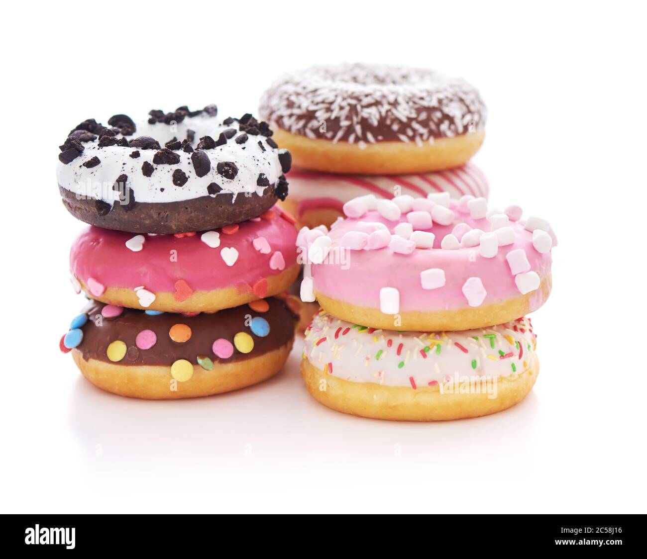 Stack of glazed doughnuts with sprinkles on white background Stock Photo