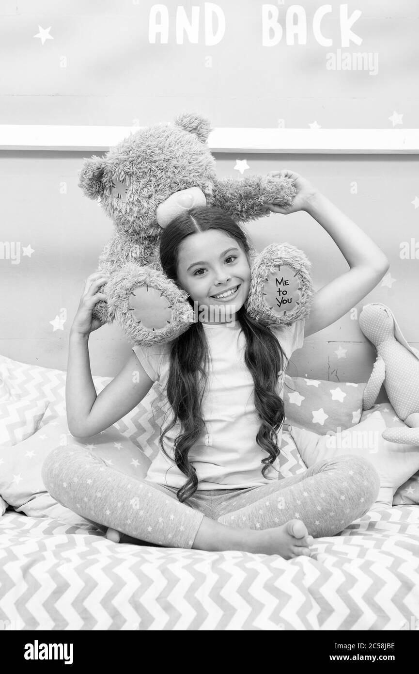 Playing together. Happy child play with teddy bear. Little kid enjoy playing in nursery. Role