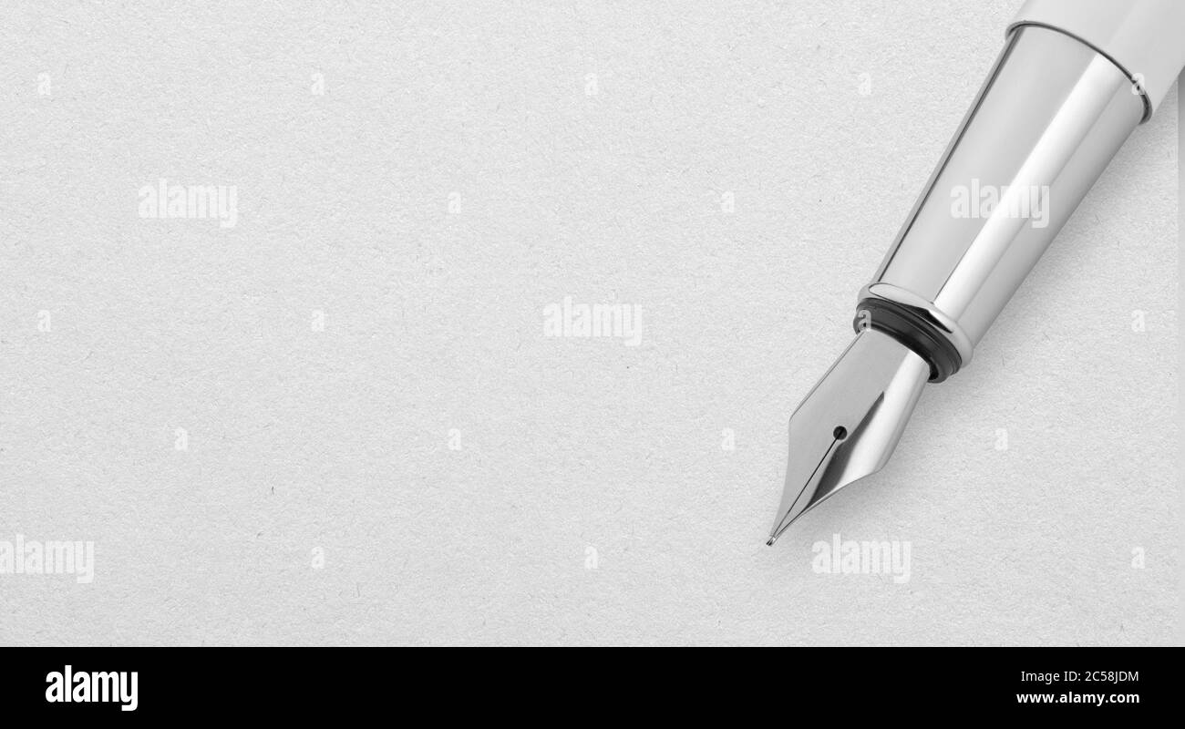 Silver Fountain Pen on a white paper sheet with copy space. Clipping path included Stock Photo