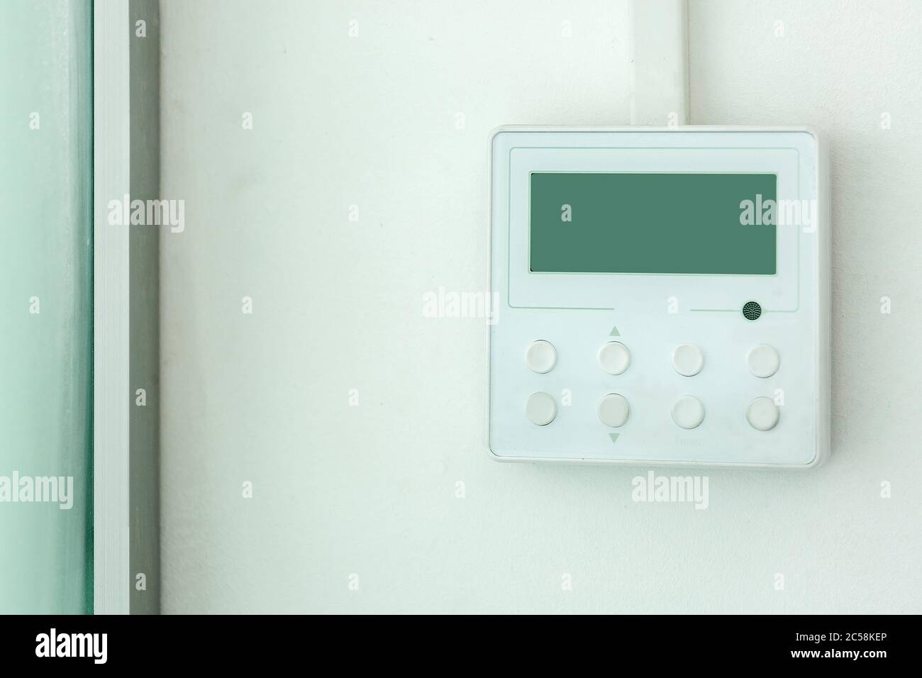 white wall air conditioning control panel with screen and control