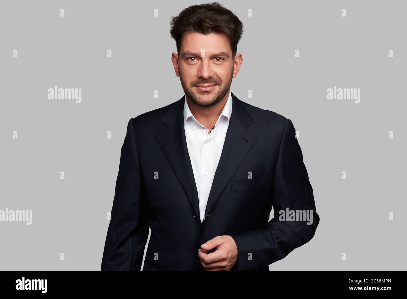 Handsome macho man on grey hi-res stock photography and images - Alamy