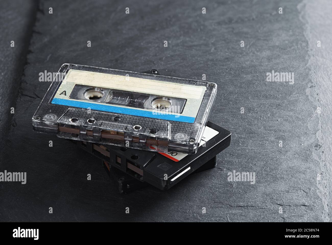 Three audio tape compact cassettes on stone background Stock Photo