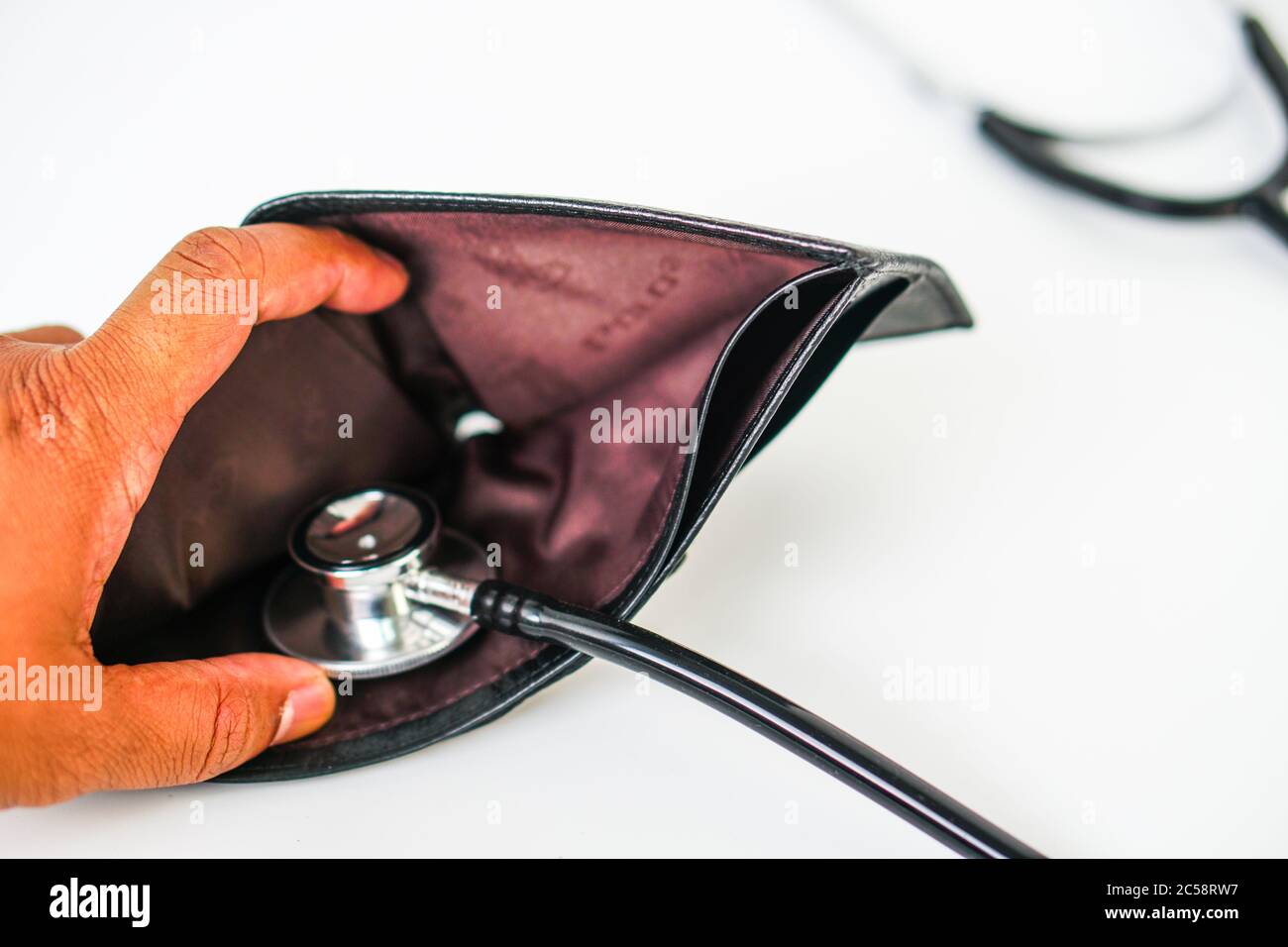 Diagnose finance situation with a stethoscope and cash wallet Stock Photo