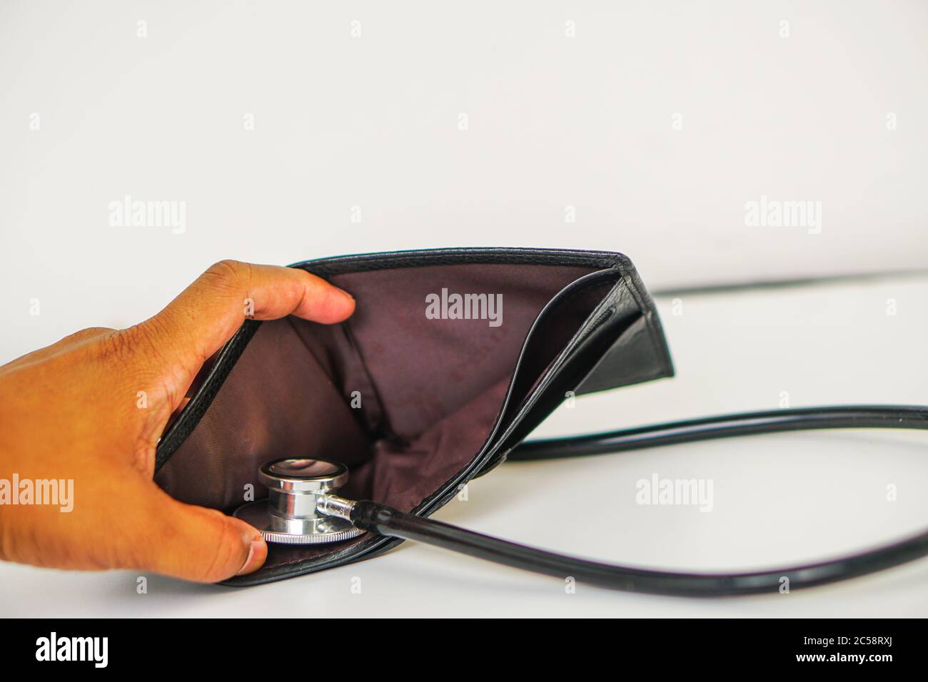 Diagnose finance situation with a stethoscope and cash wallet Stock Photo
