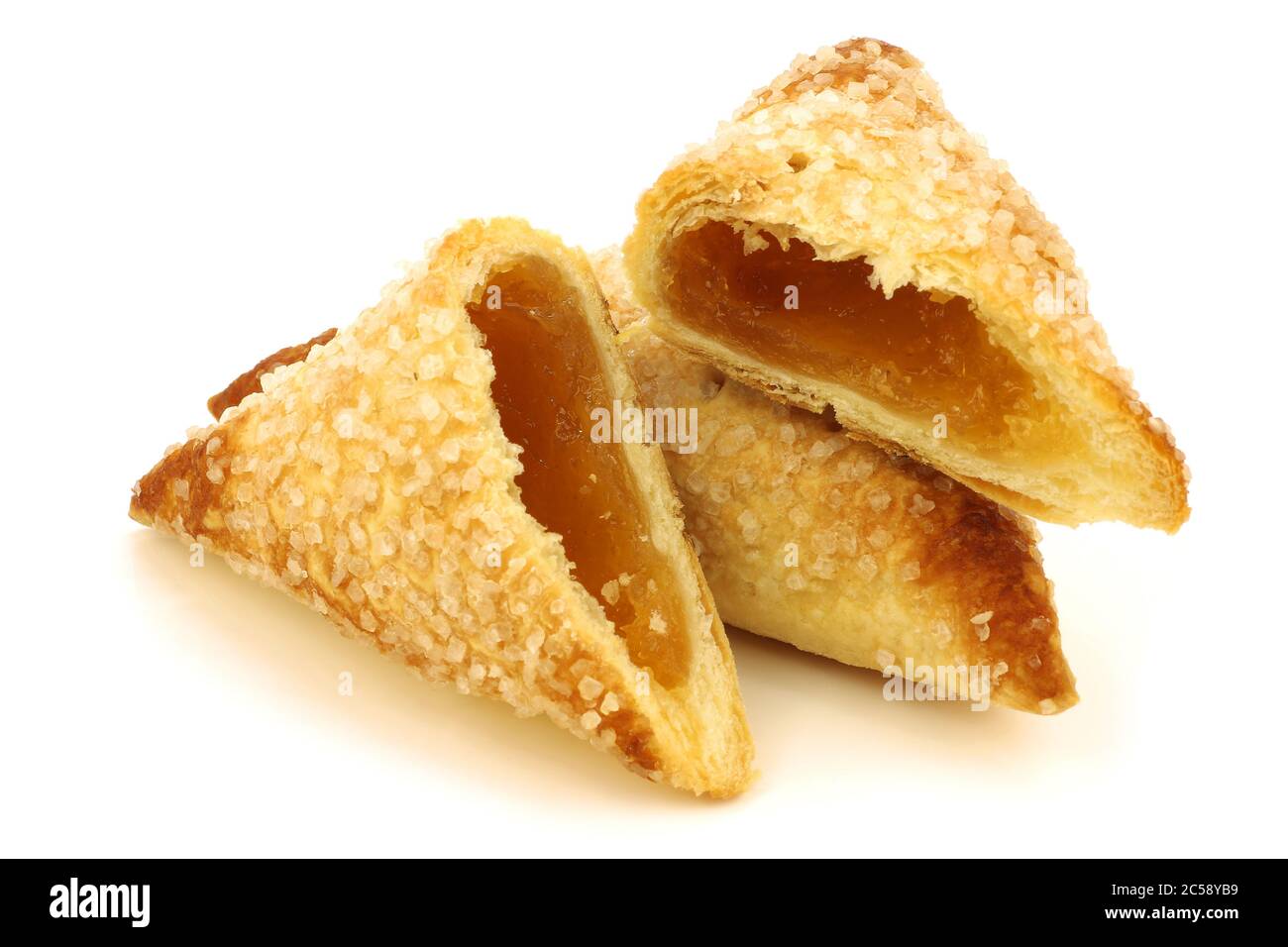 freshly baked apricot turnover and a cut one  on a white background Stock Photo