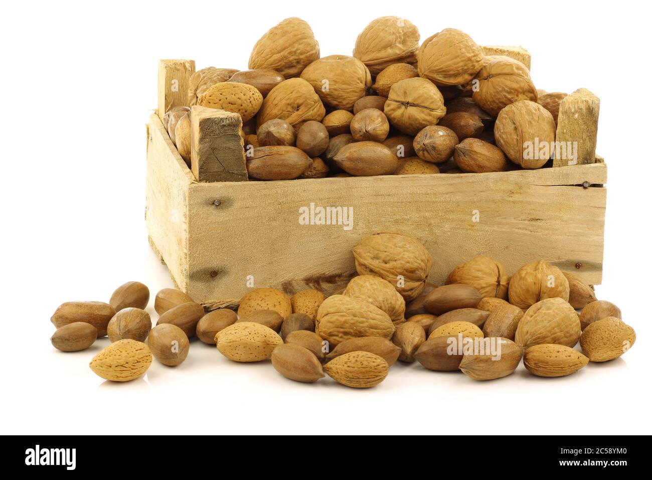 assorted nuts in a wooden box on a white background Stock Photo
