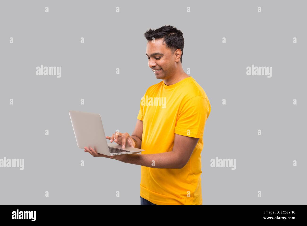 Indian Man Using Laptop. Home orders, Quarantine delivery, Shopping Online, Freelance Worker Concept. Stock Photo