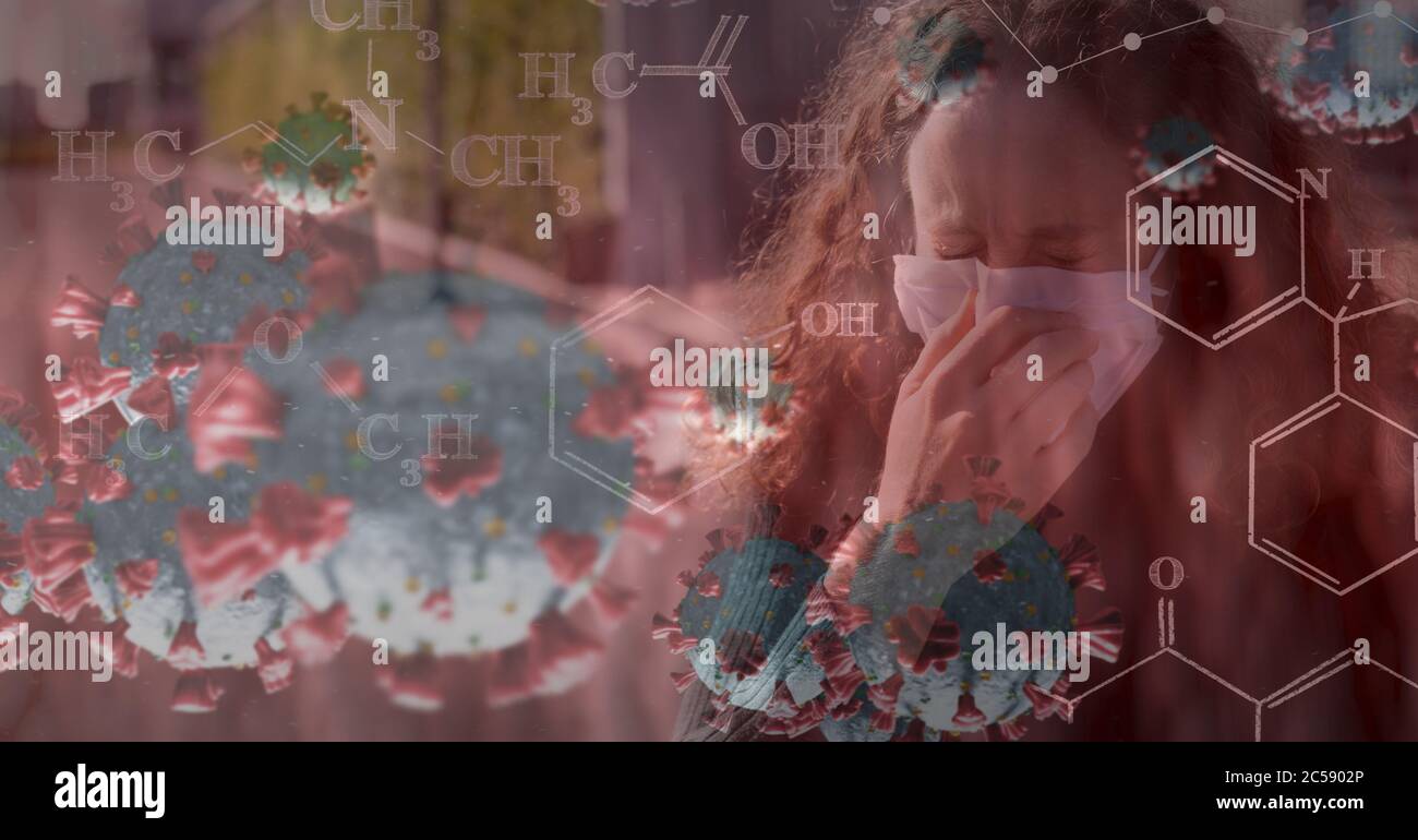 Covid-19 cells and chemical structures against woman wearing face mask sneezing Stock Photo