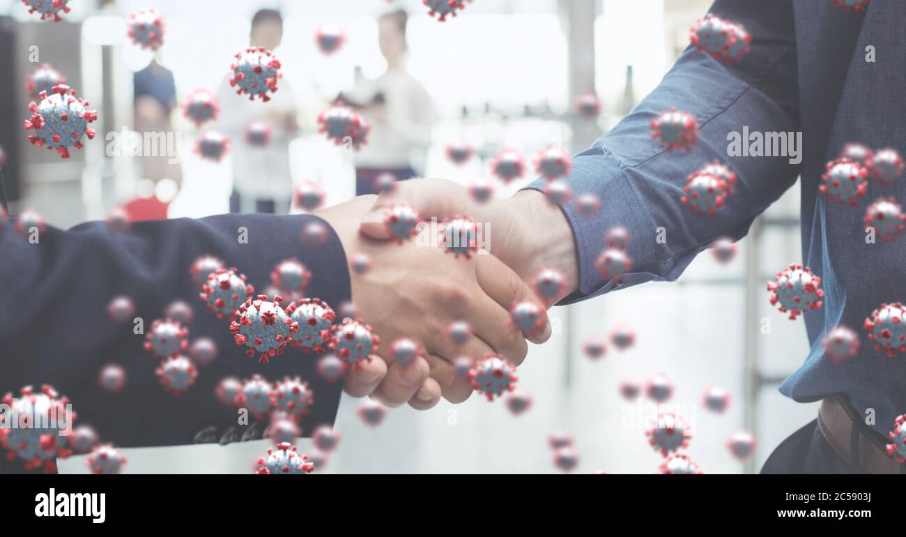 Covid-19 cells against two people shaking hands Stock Photo
