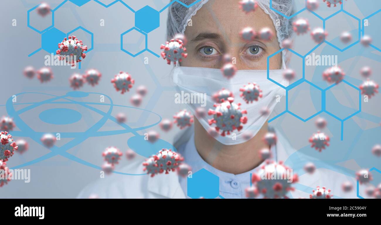 Covid-19 cells and chemical structure against scientist wearing face mask Stock Photo