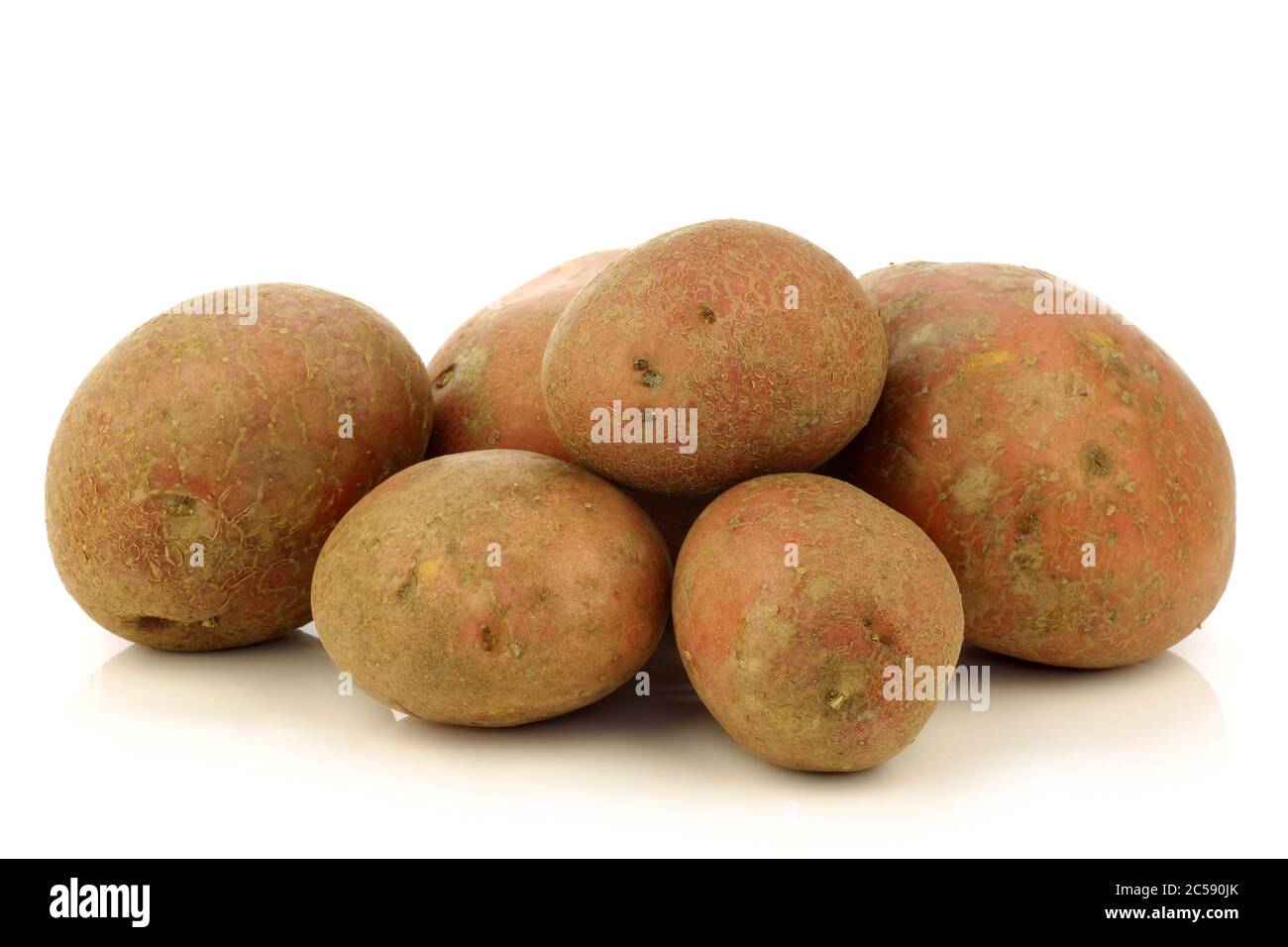 freshly harvested dutch potatoes called 'Bildtstar' and a peeled one on a white background Stock Photo