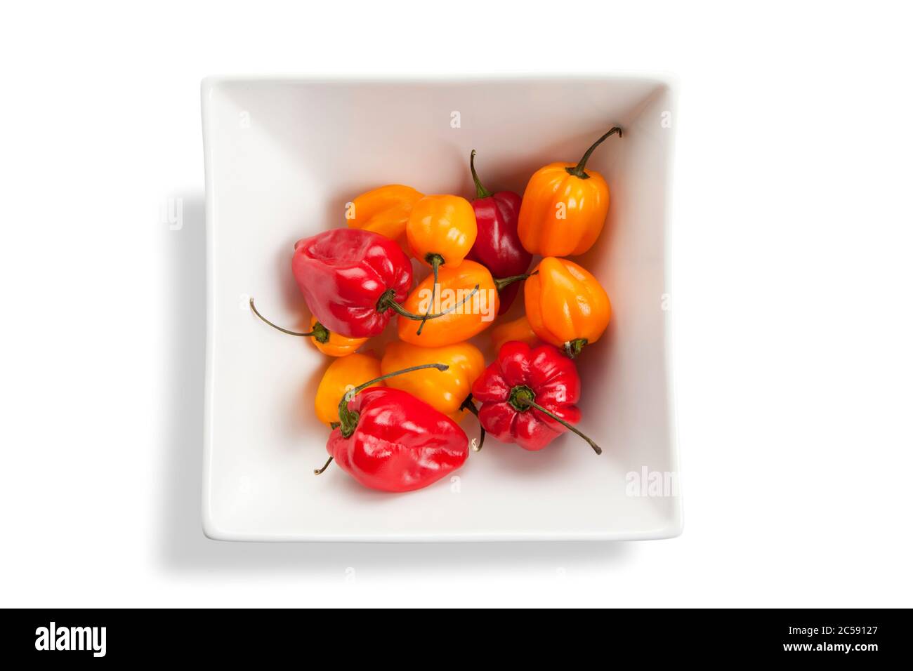 red and yellow habeneros in square bowl isolated on white Stock Photo