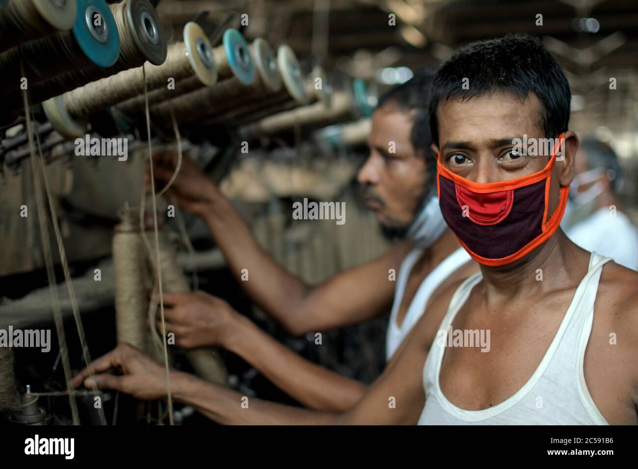DHAKA, BANGLADESH - 01JULY 2020:  Workers busy in making jute sacks at jute processing mill in Narayanganj near Dhaka,. Jute Industry in Bangladesh is an industry that is historically and culturally important that once was the biggest industry in the region. Stock Photo