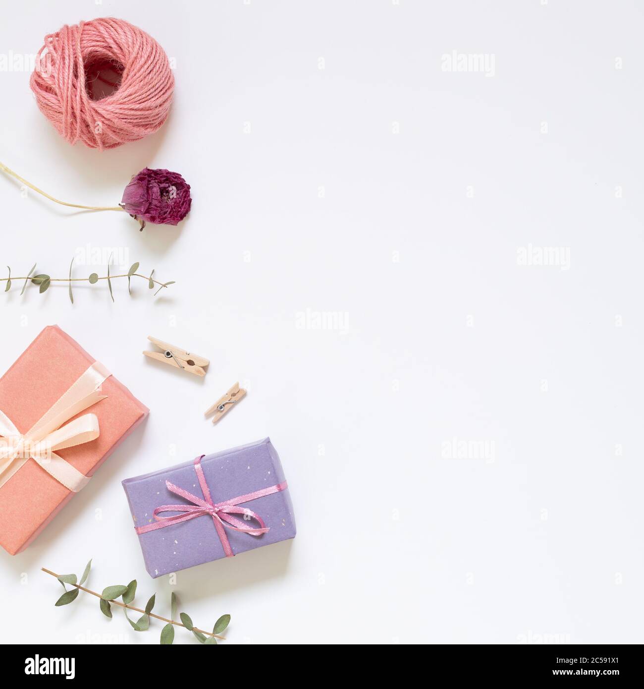 Gift boxes with wrapping tools on white background. top view, copy space Stock Photo