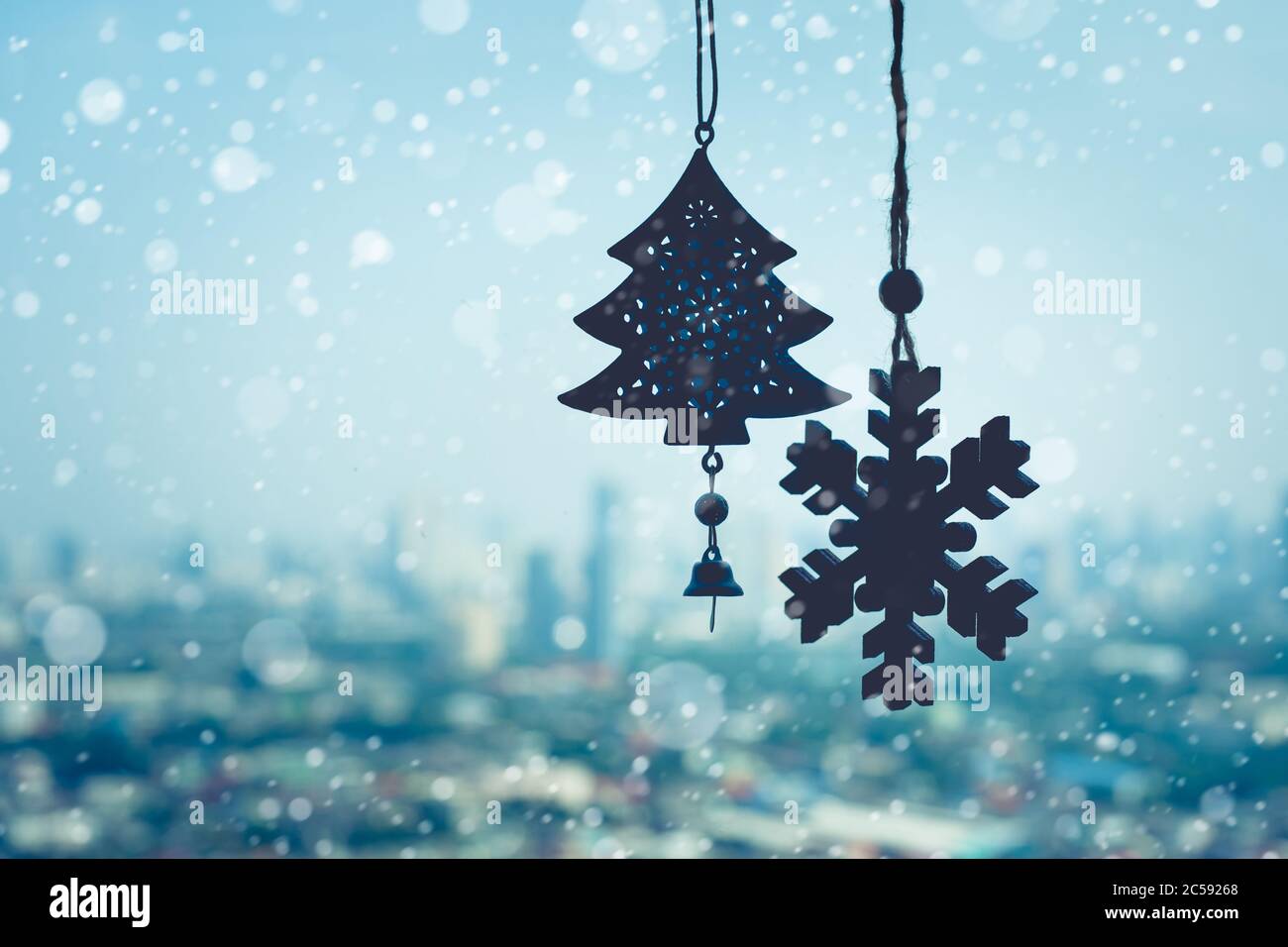 christmas ornament ( Snowflake ) hanging mobile on window with blur outdoor landscape background.season and holiday concepts Stock Photo