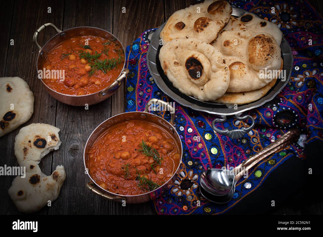 Indian chickpea garbanzo chole masala curry with naan in traditional