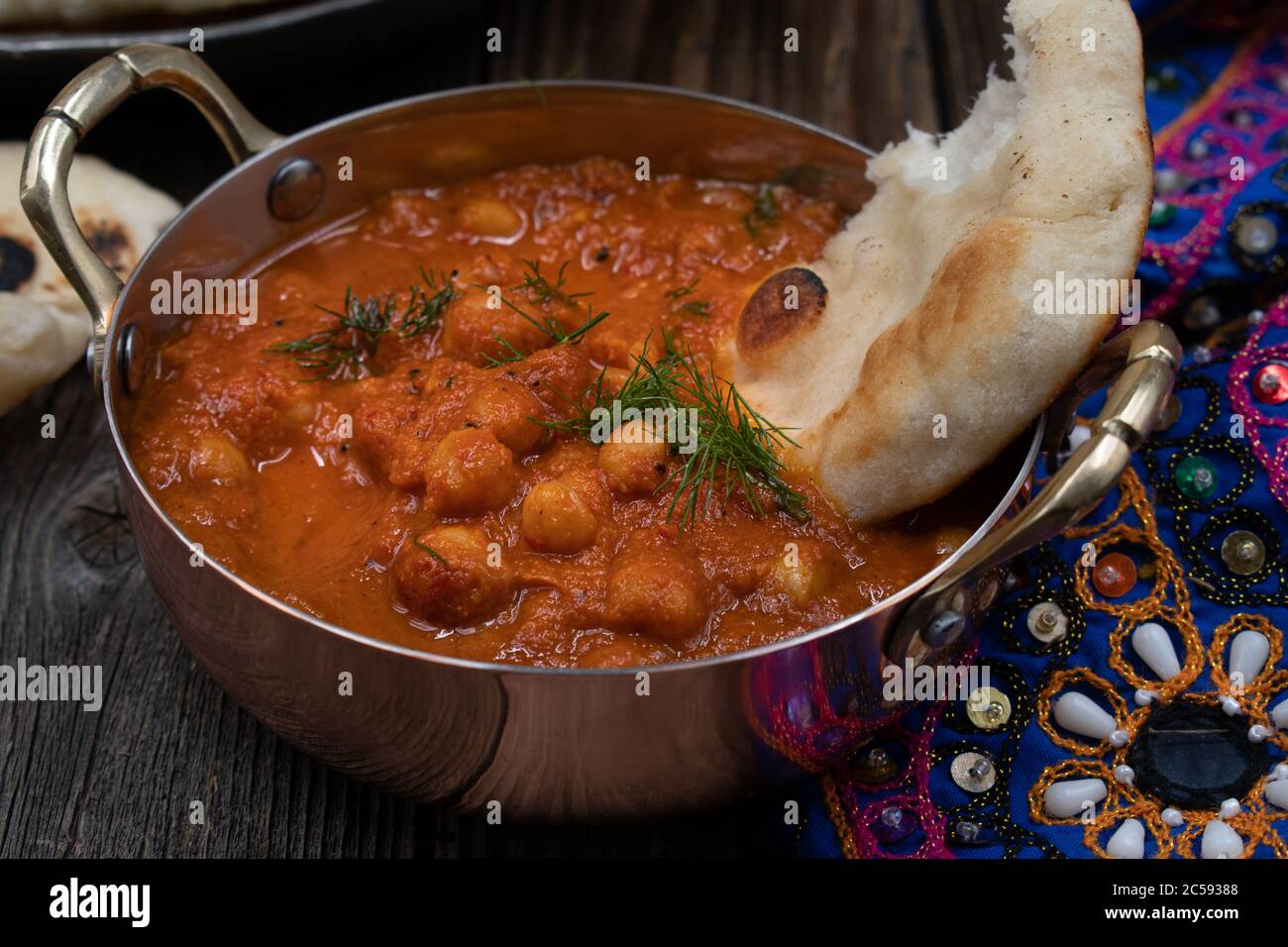Indian chickpea garbanzo chole masala curry with naan in traditional