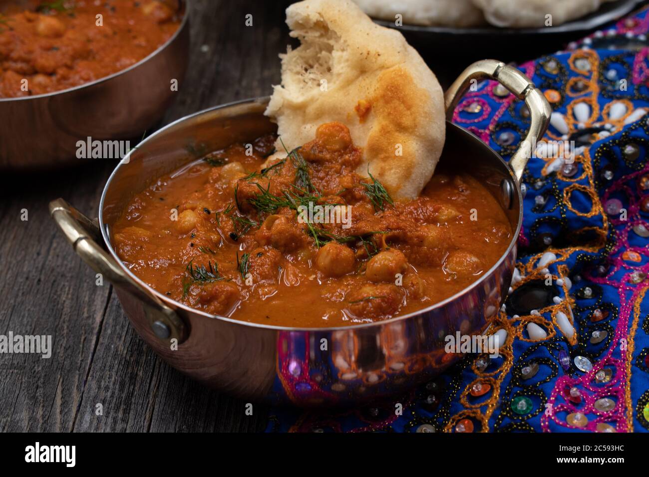 Indian chickpea garbanzo chole masala curry with naan in traditional