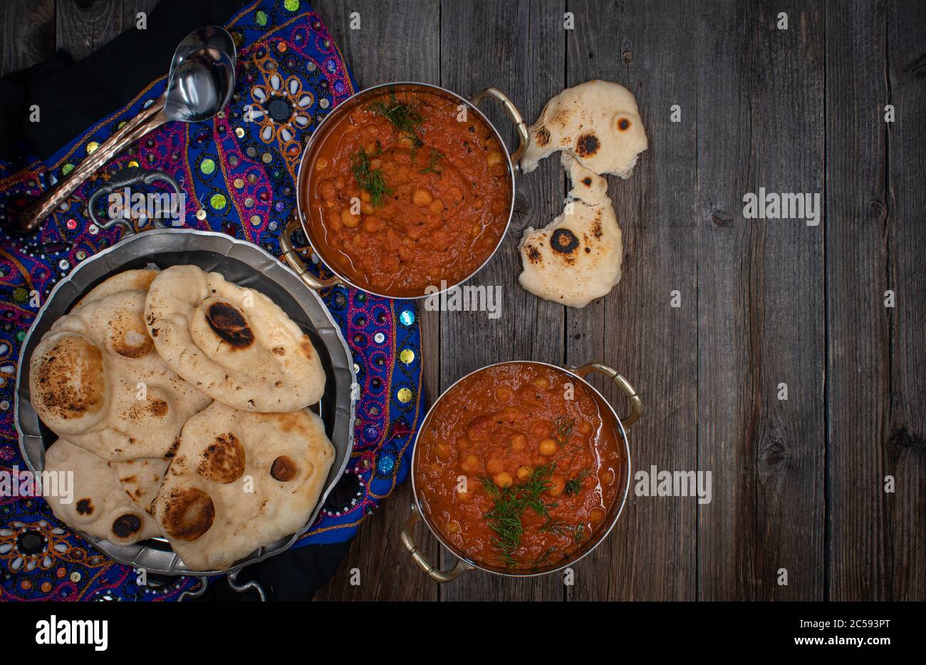 Indian chickpea garbanzo chole masala curry with naan in traditional