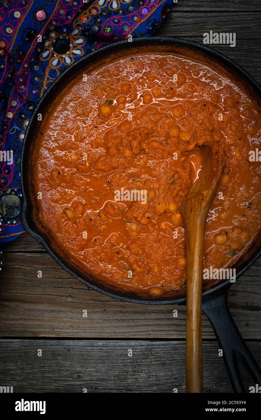 Indian chickpea garbanzo chole masala curry in cast iron pan, copy