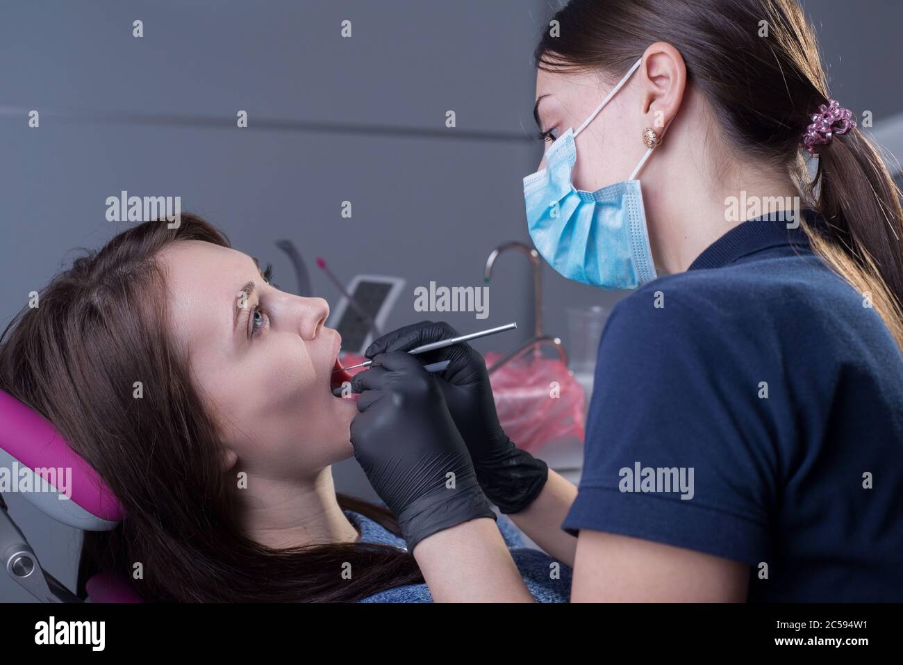 closeup portrait in the dental office. Doctor dentist general practitioner examines a patient