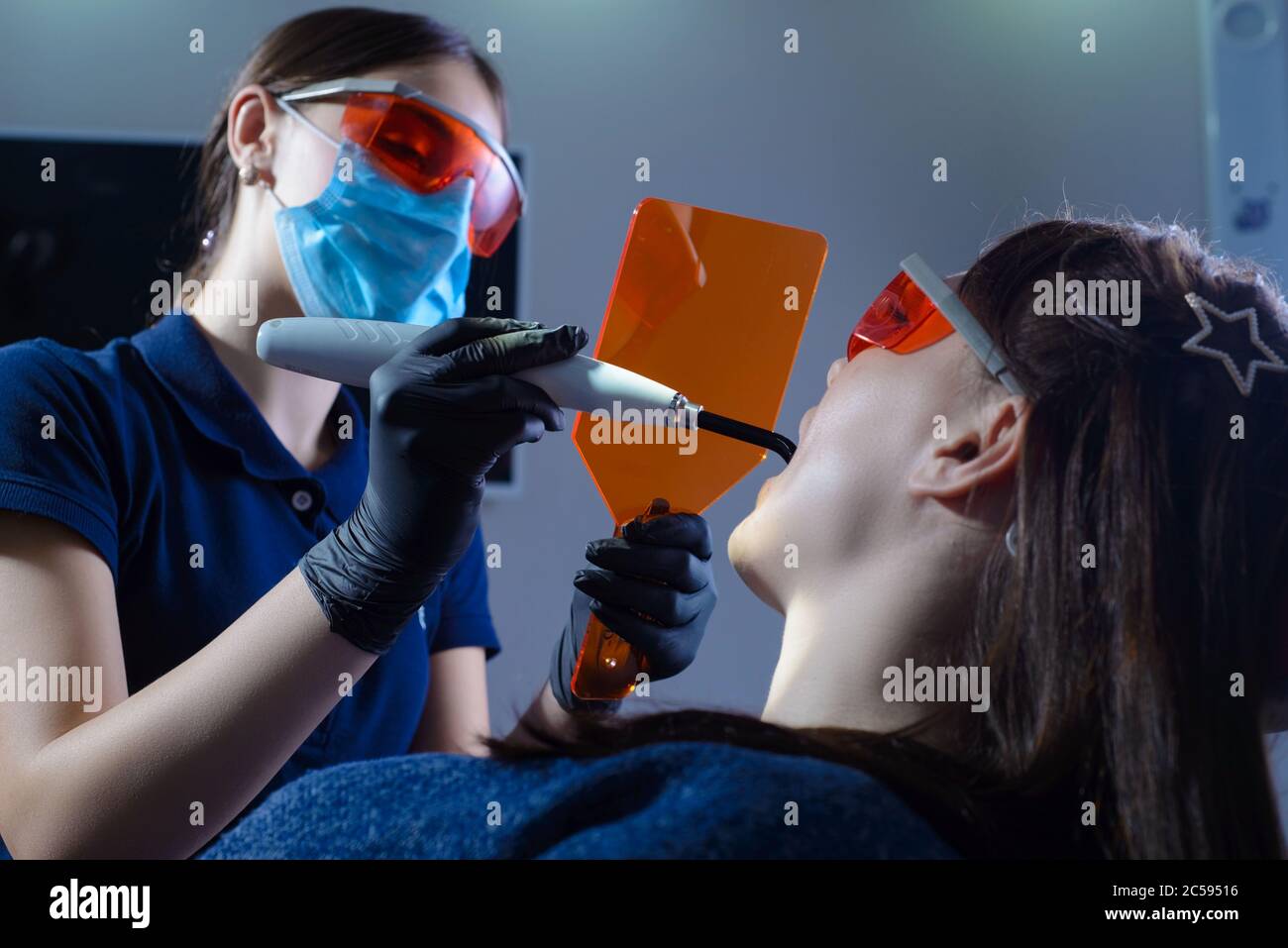 Portrait of a dentist doctor performing the procedure of professional