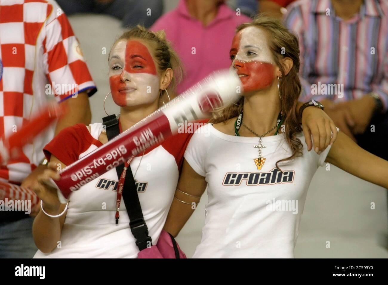 Split, Croatia - 17 August, 2005: Two fiery cheerleaders in the stands during the friendly football game Croatia - Brazil in split 2005 Stock Photo