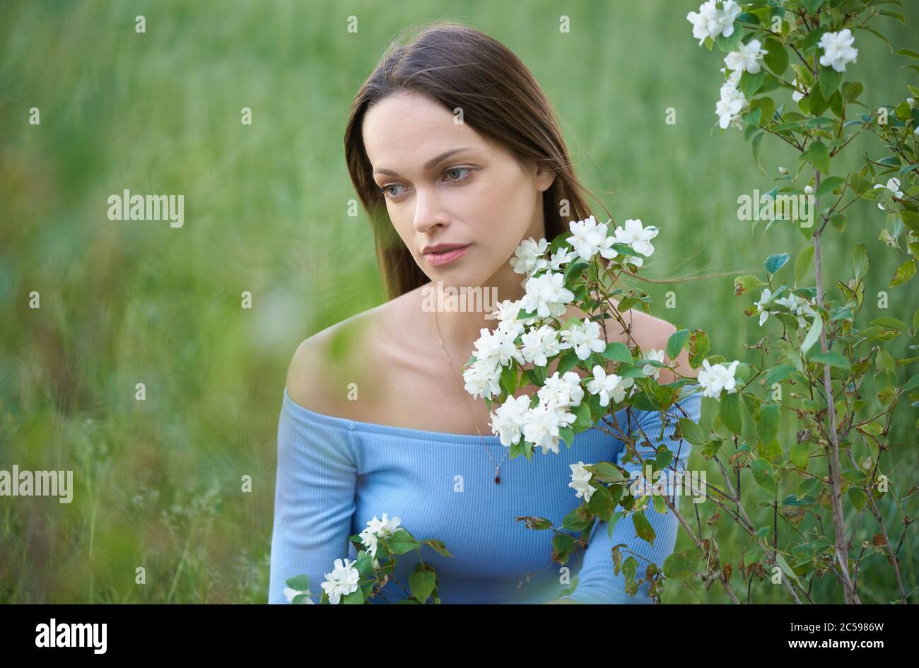 Sad girl sitting grass hi-res stock photography and images - Alamy
