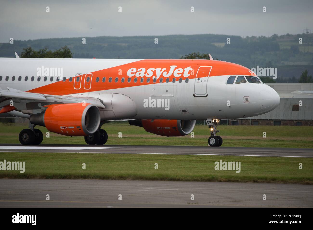 Glasgow, Scotland, UK. 1st July, 2020. Pictured: EasyJet flight from Belfast to Glasgow seen landing at Glasgow. EasyJet says it has begun consultations on plans to close bases at Stansted, Southend and Newcastle. The airline said it is having to introduce cost cutting measures in order to survive the effects of the coronavirus crisis on the airline industry. The Unite union said nearly 1,300 UK crew members faced losing their jobs. Today saw the first day back of full flight schedule releases. Credit: Colin Fisher/Alamy Live News Stock Photo