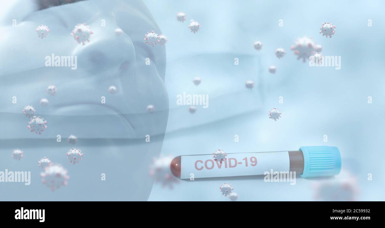 Covid-19 cells against test tube with Covid-19 text and face mask Stock Photo