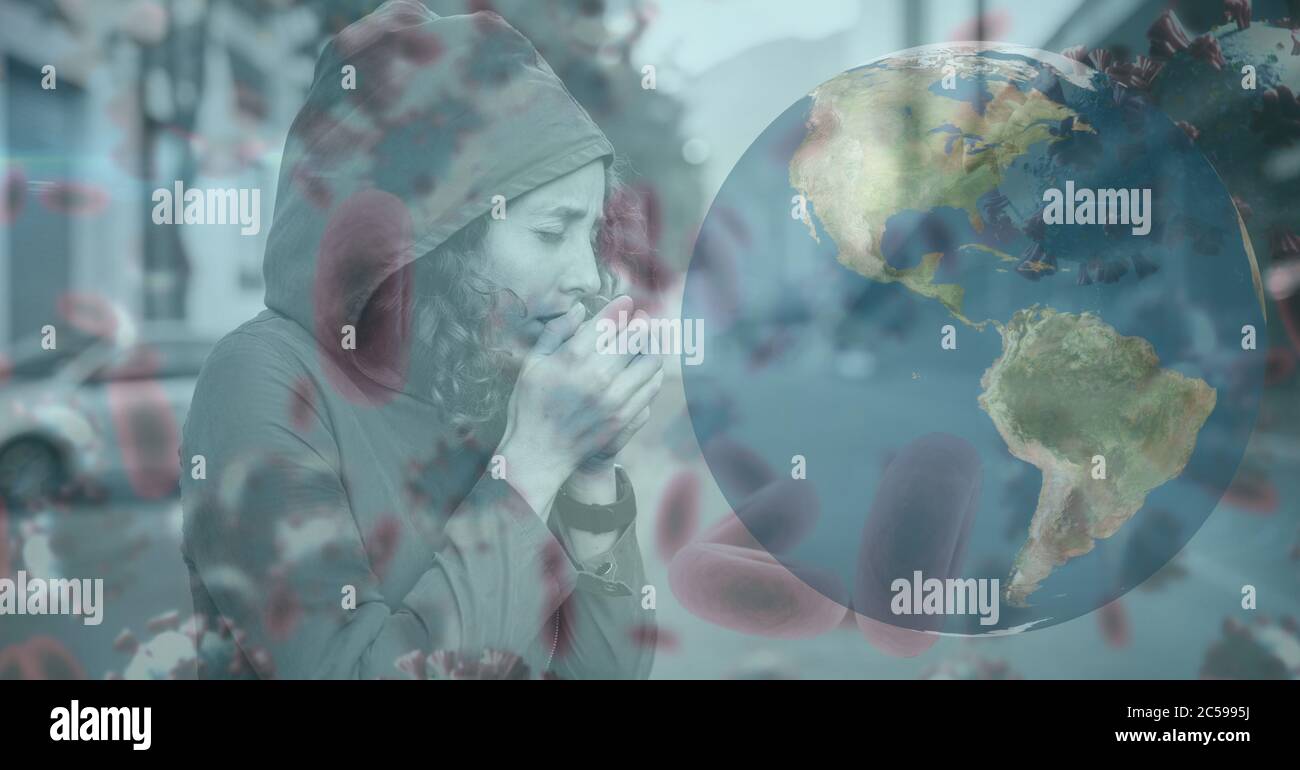 Covid-19 cells and globe against woman wearing face mask sneezing Stock Photo