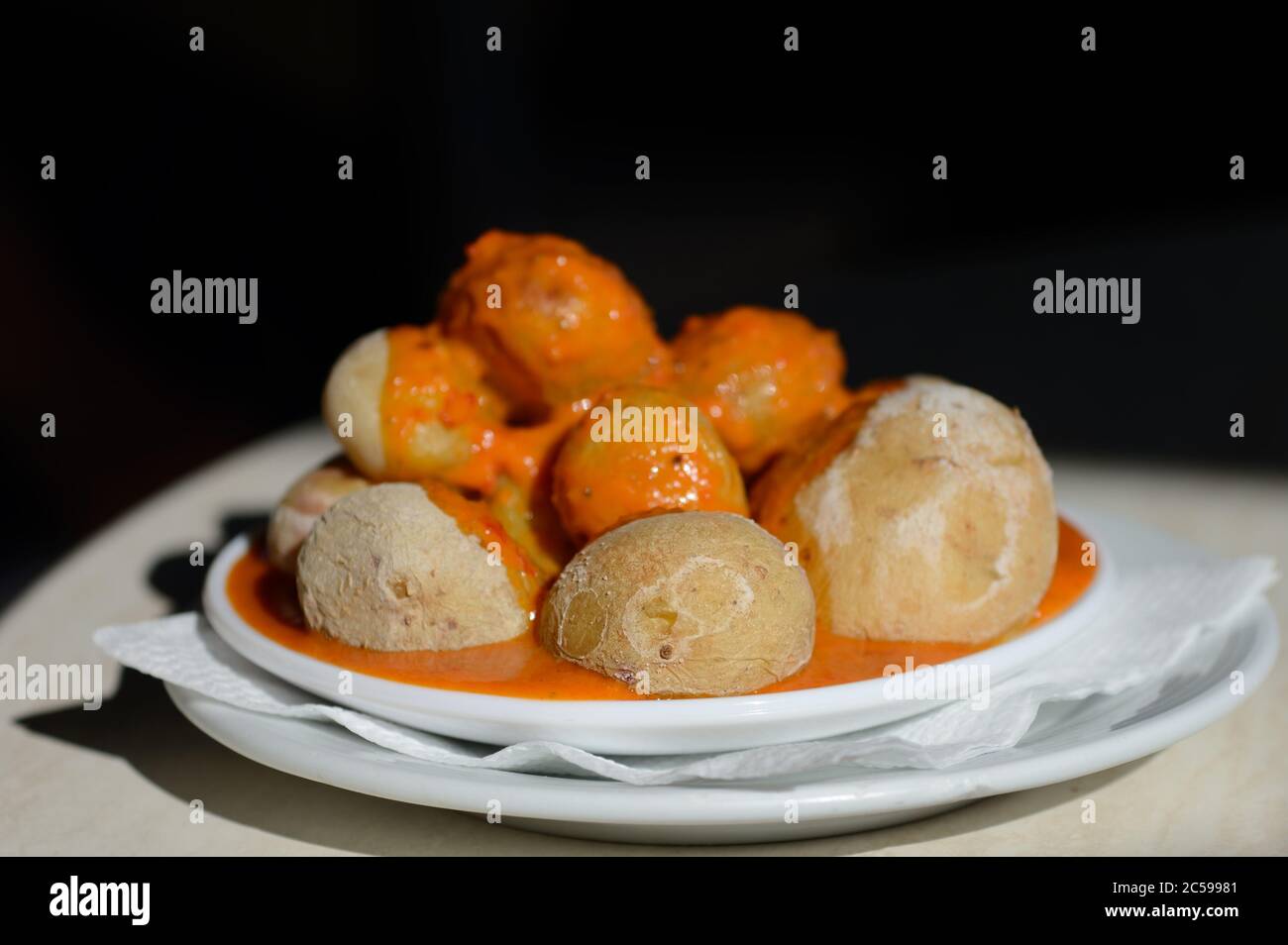 Canarian Salt Wrinkled Potatoes Papas Arrugadas with spicy red pepper sauce mojo rojo Stock Photo
