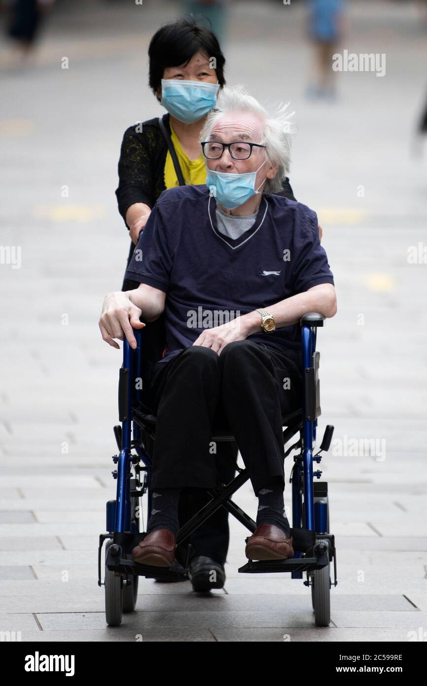 Elderly woman wearing blue hi-res stock photography and images - Alamy