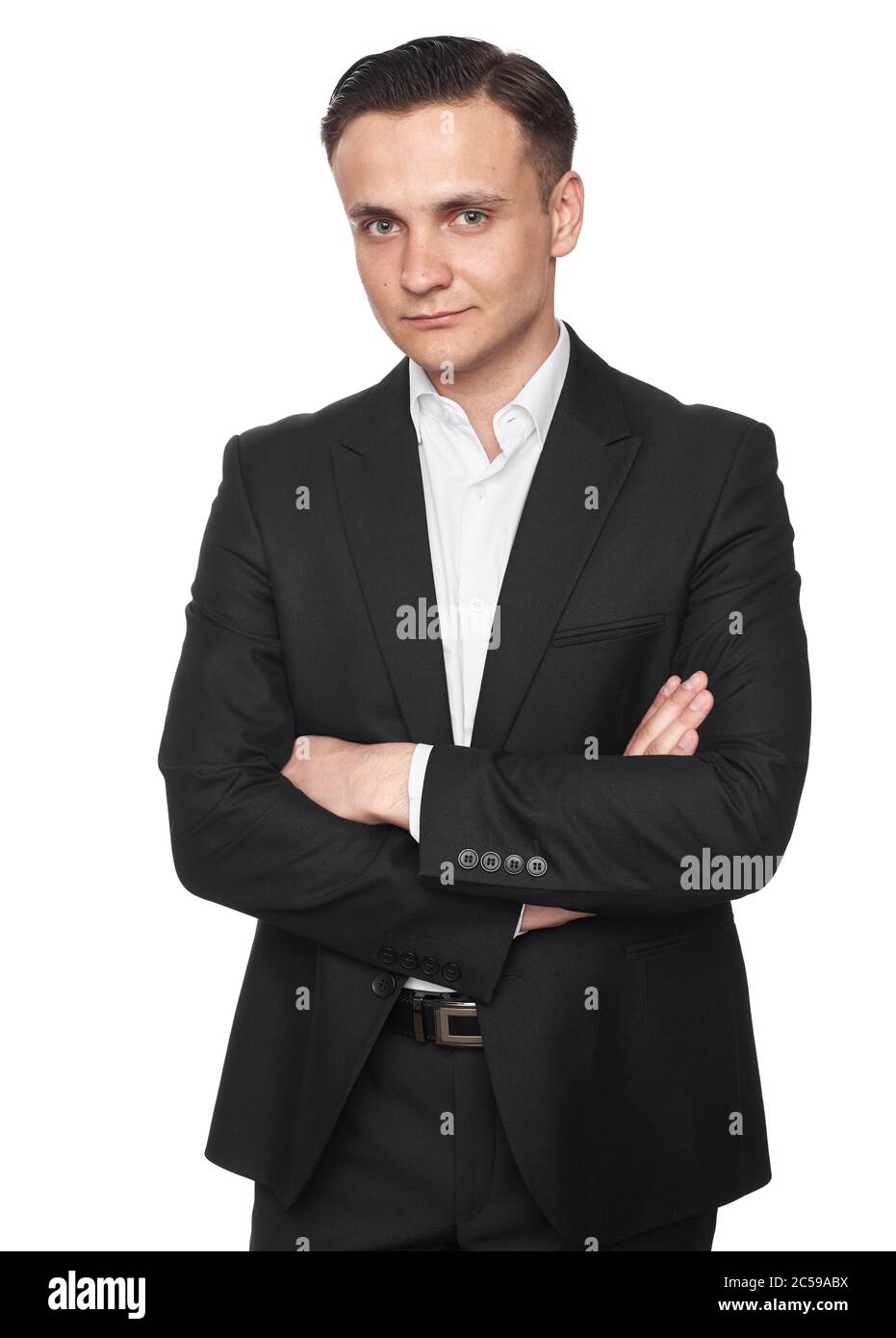 Young man in black suit with arms crossed isolated on white background ...