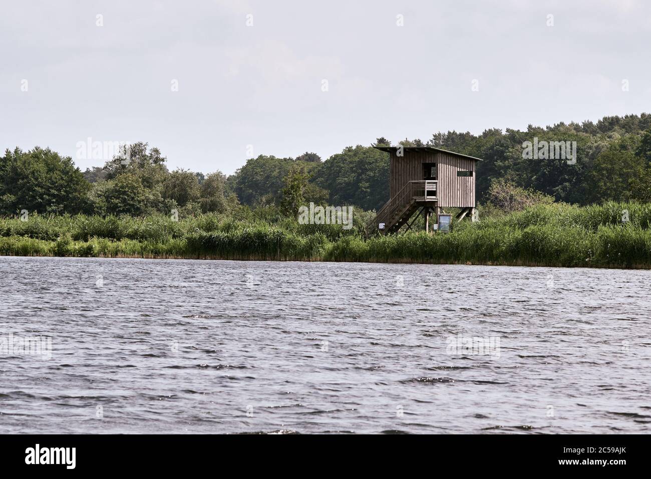 Bird blind and grassy landscape at nature reserve 'Meißendorf Lakes and Bannetze Moor' in Winsen, Germany Stock Photo